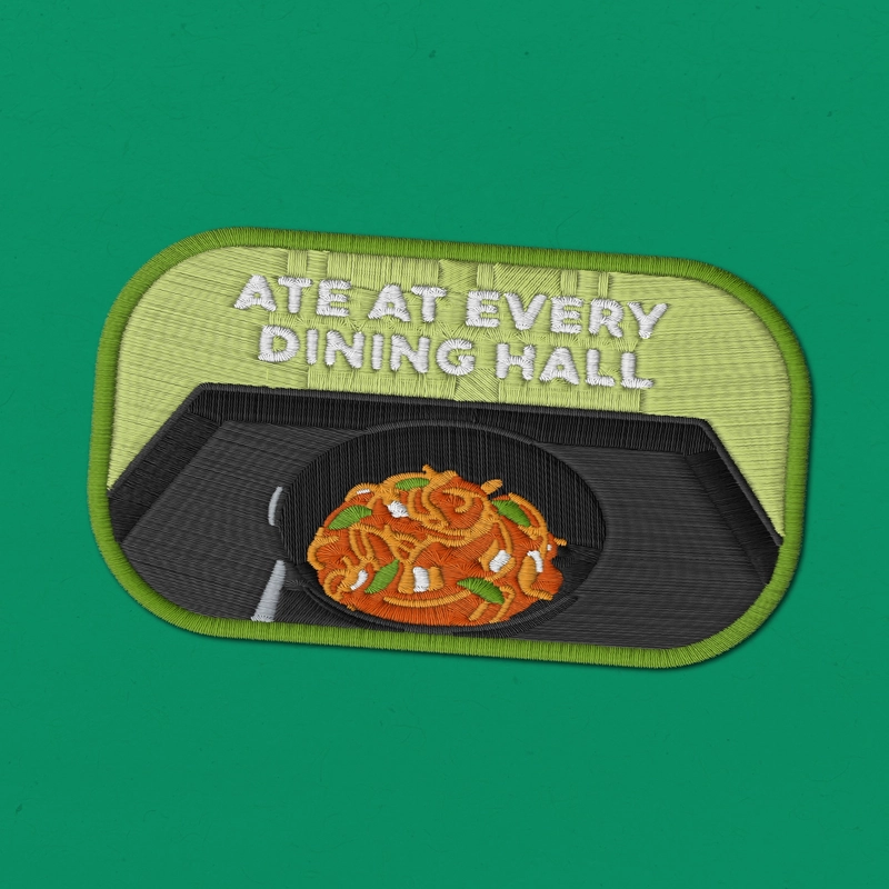Embroidered patch reading "Ate at every dining hall" with a light green background and a black tray containing a bowl of food and utensil.