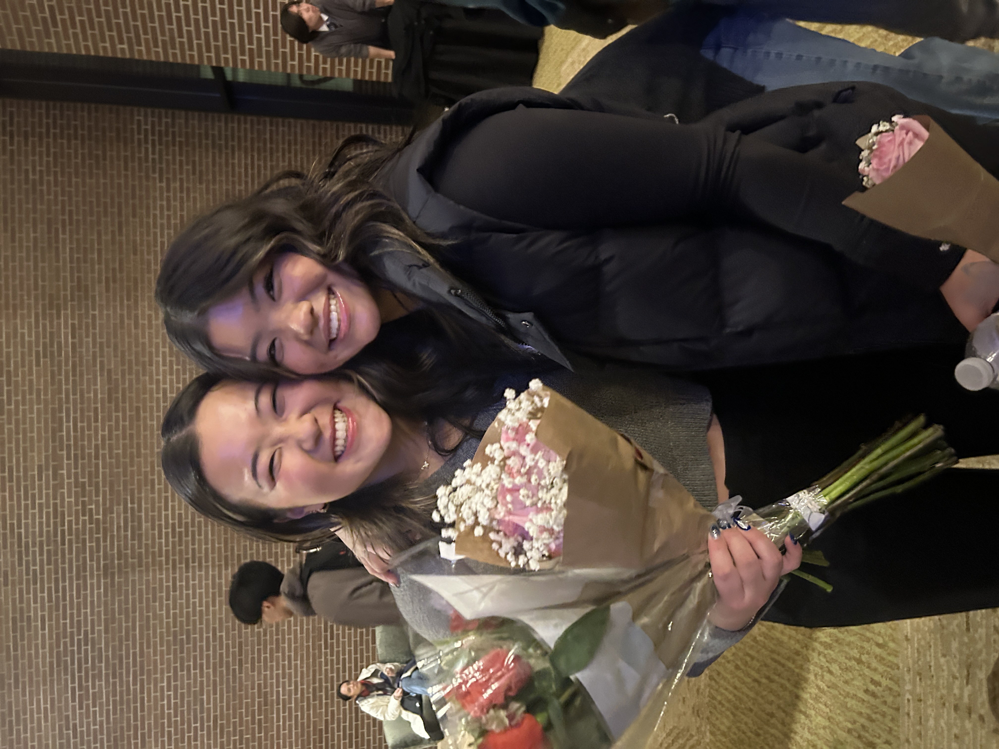 Two women holding flowers