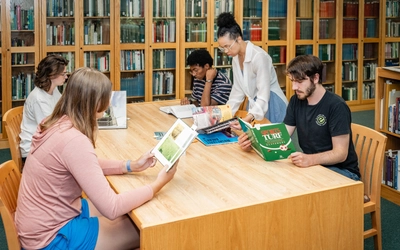 Students in the turfgrass management program reading books as research.