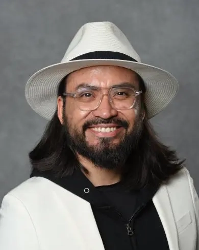 Portrait of Jose Mendoza Cortes smiling.