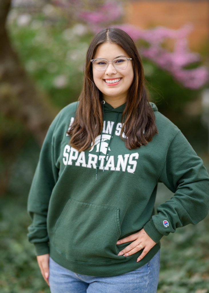 student wearing spartan sweater