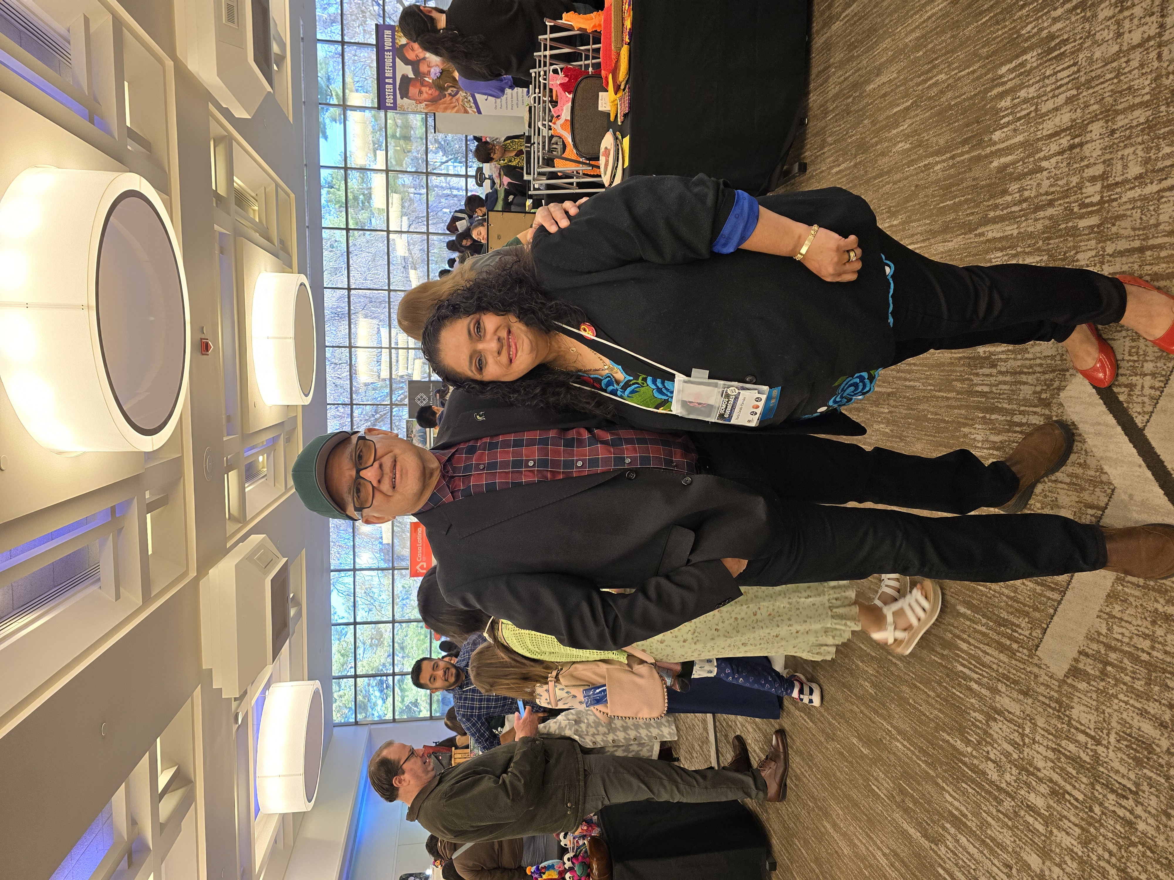 A man and woman standing in a convention room