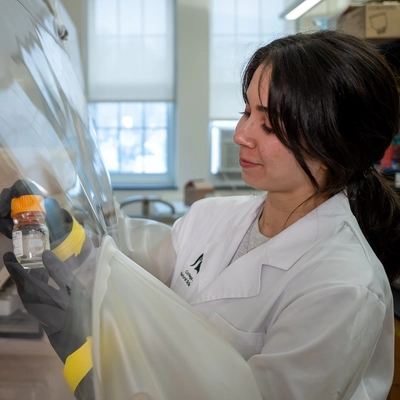 Student holding a glass bottle.