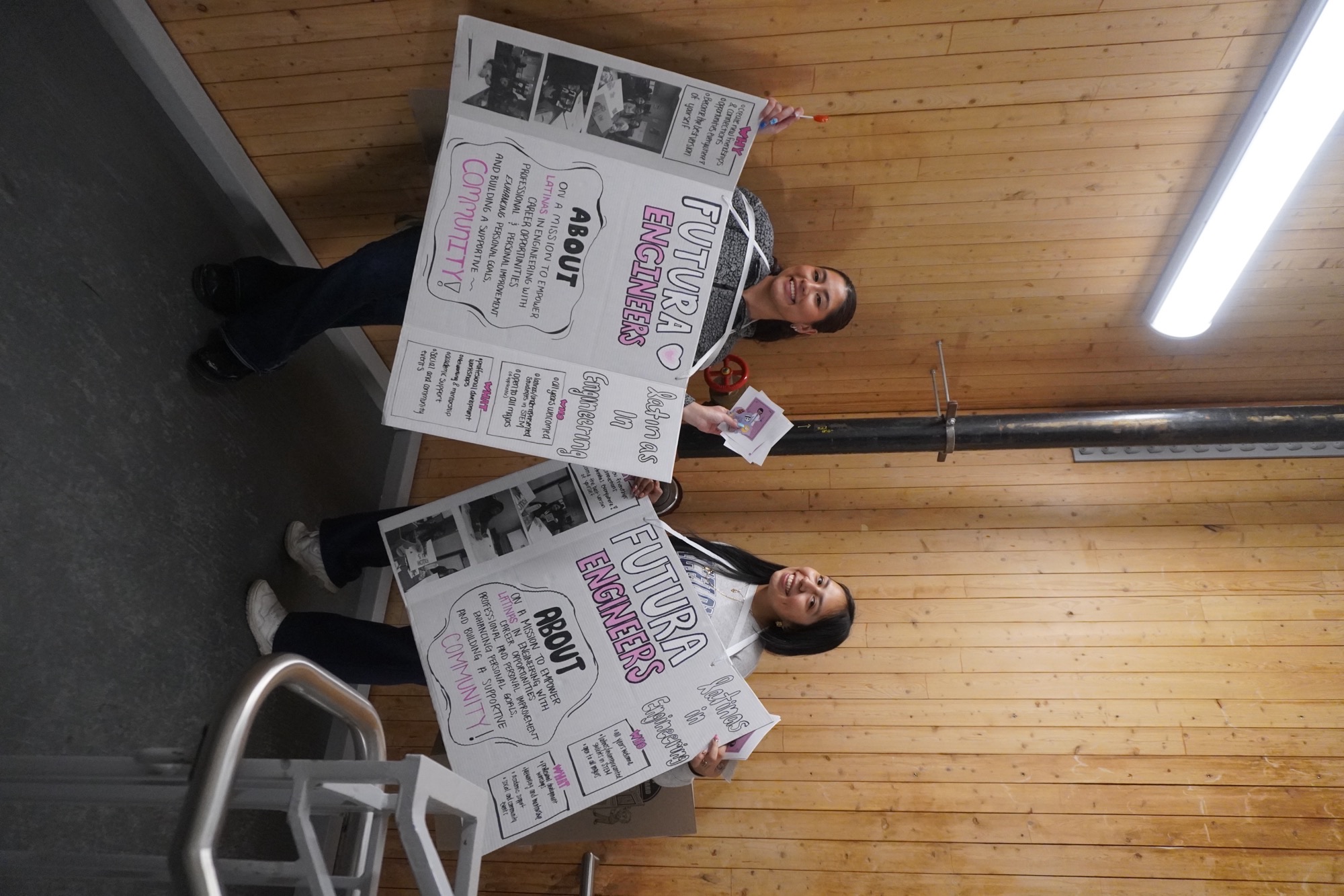two students holding poster boards