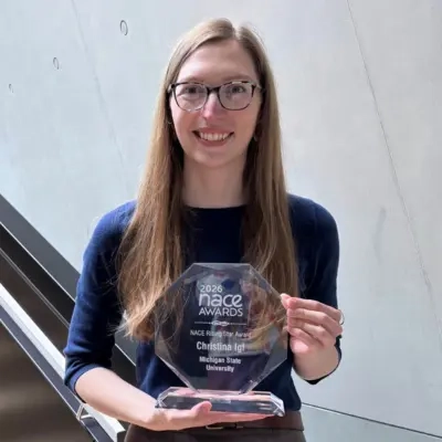 Christina Igl holds a glass 2026 NACE Award for Rising Star.