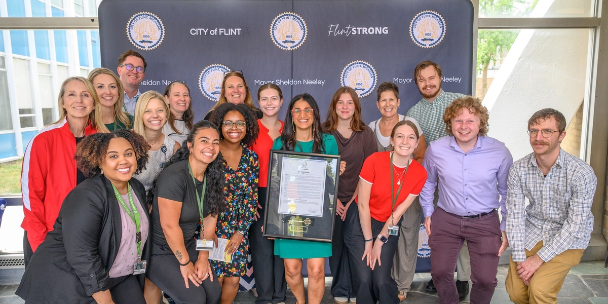 MSU College of Medicine Flint staff holding award
