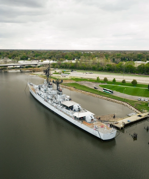 Aerial view of the USS Edson floating in a bay
