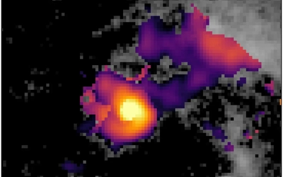 An image of a purple, yellow, orange and pink blob surrounded by black and gray space.