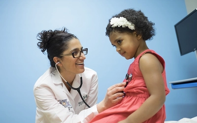 Dr. Mona Hanna examines a young patient at Hurley Children’s Hospital in Flint.