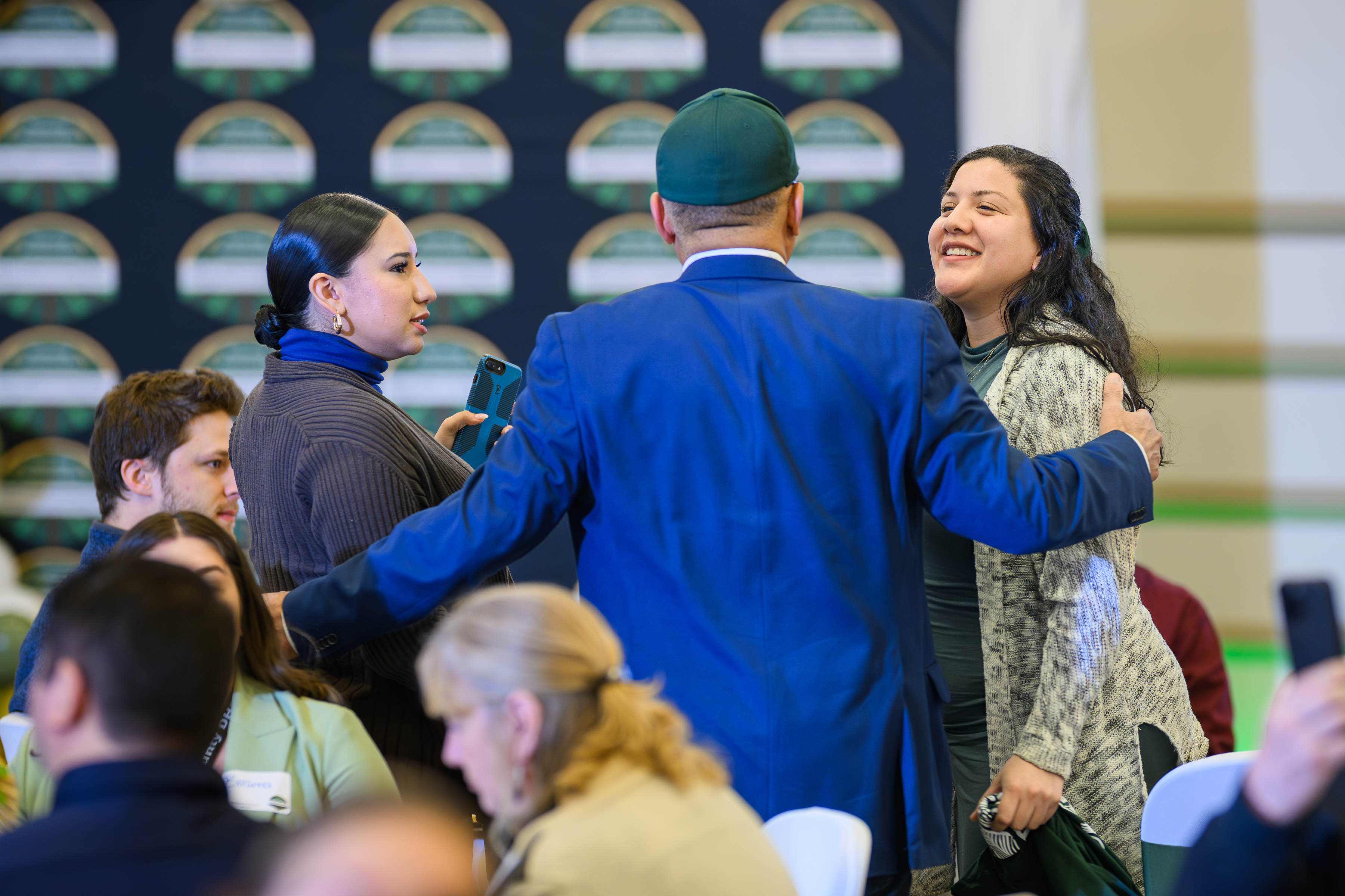 Two students speak with a staff member