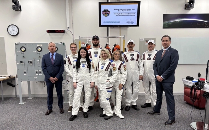 NASA engineer and MSU alum Nicholas Houghton and his team of technicians and engineers in white NASA technician uniform suits.