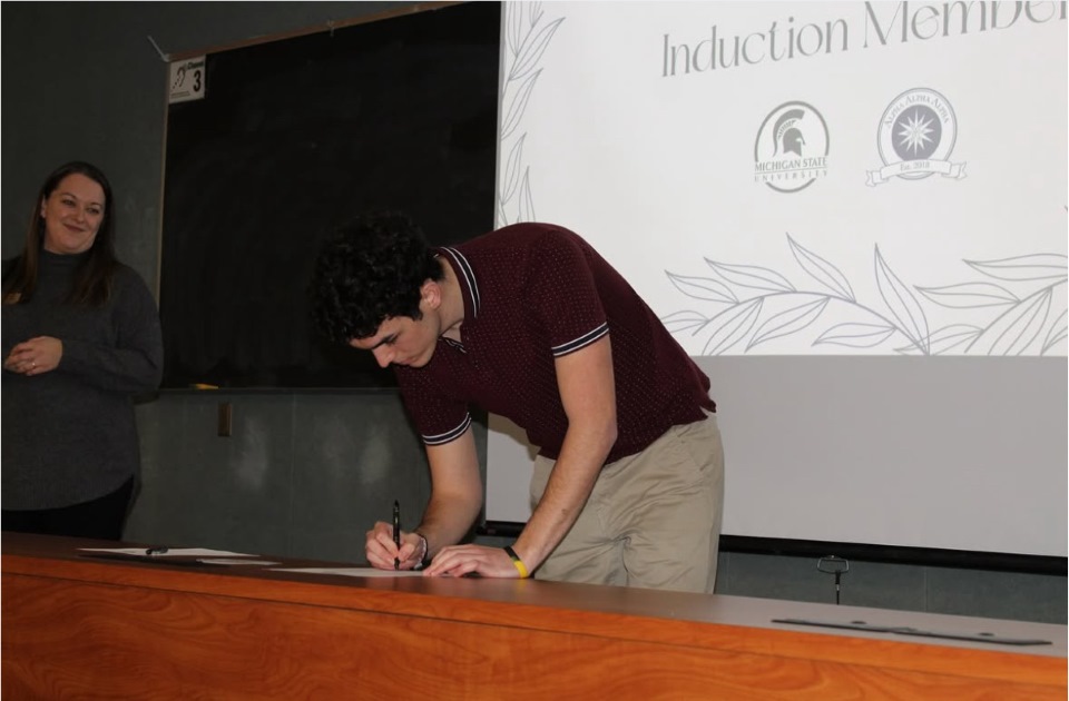 a man signs a piece of paper