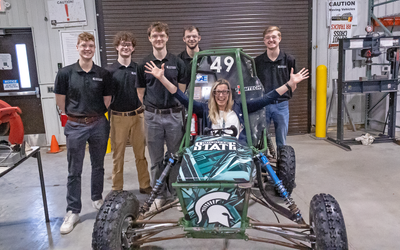 Laura Lee McIntyre in a Baja racing car with engineering students