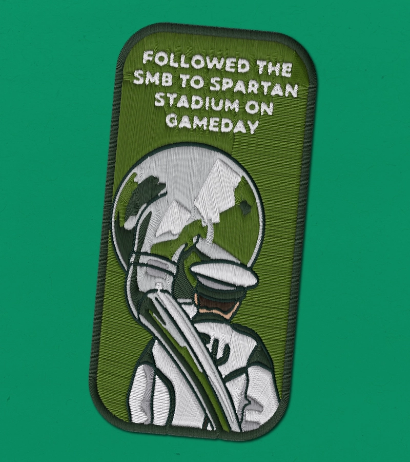 Embroidered patch reading "Followed the SMB to Spartan Stadium on Gameday" with a marching band member.