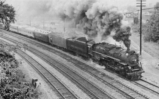 A steam train in motion.