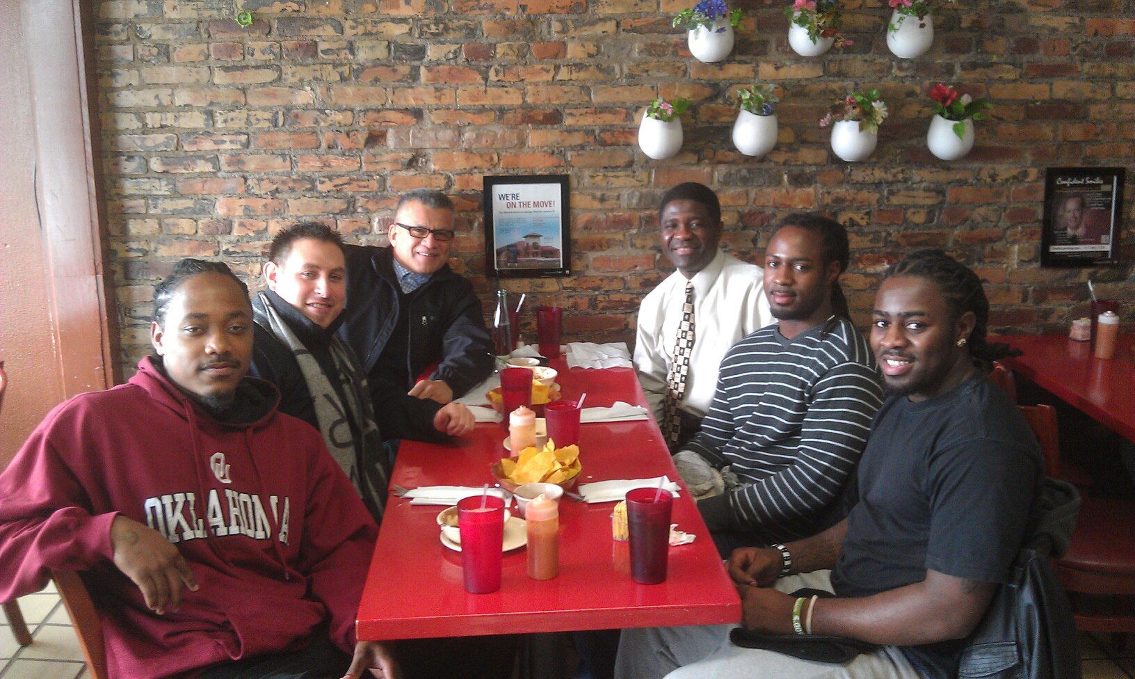 a group of men seated at a lunch establishment