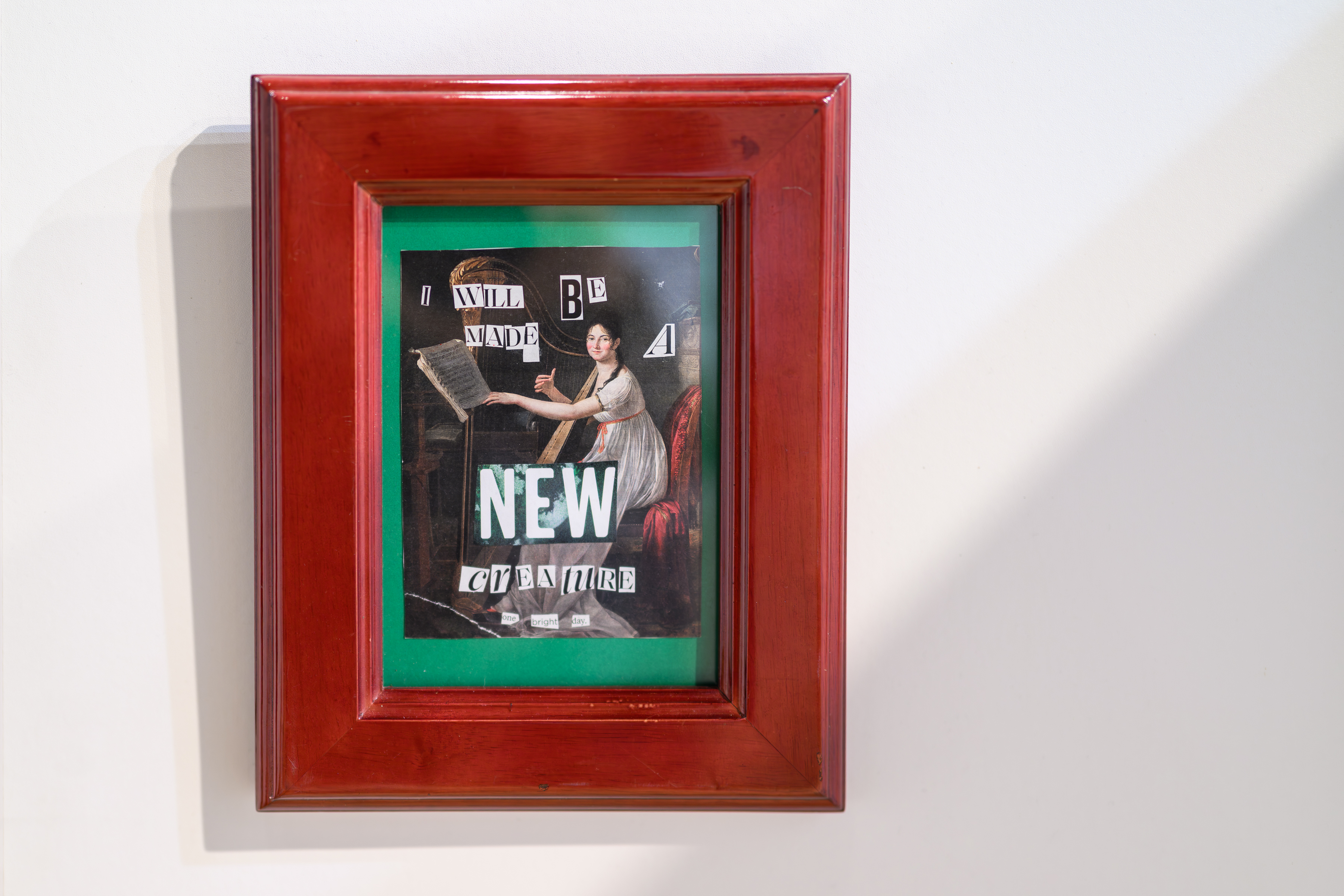 framed collage on wall with the words I will be made a new creature