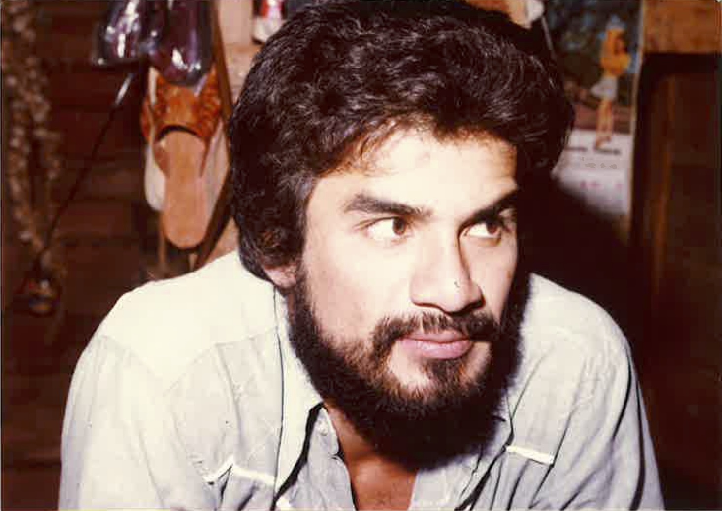 a photo from the 1980s of a man with a beard looking onward