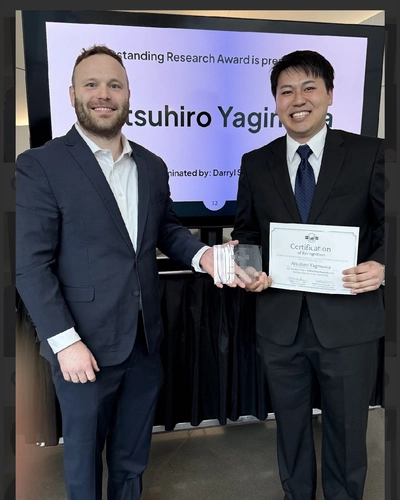 Daryl Seligman and Atsuhiro Yaginuma smile together at an event where Yaginuma won the outstanding undergraduate research award for MSU undergrads.