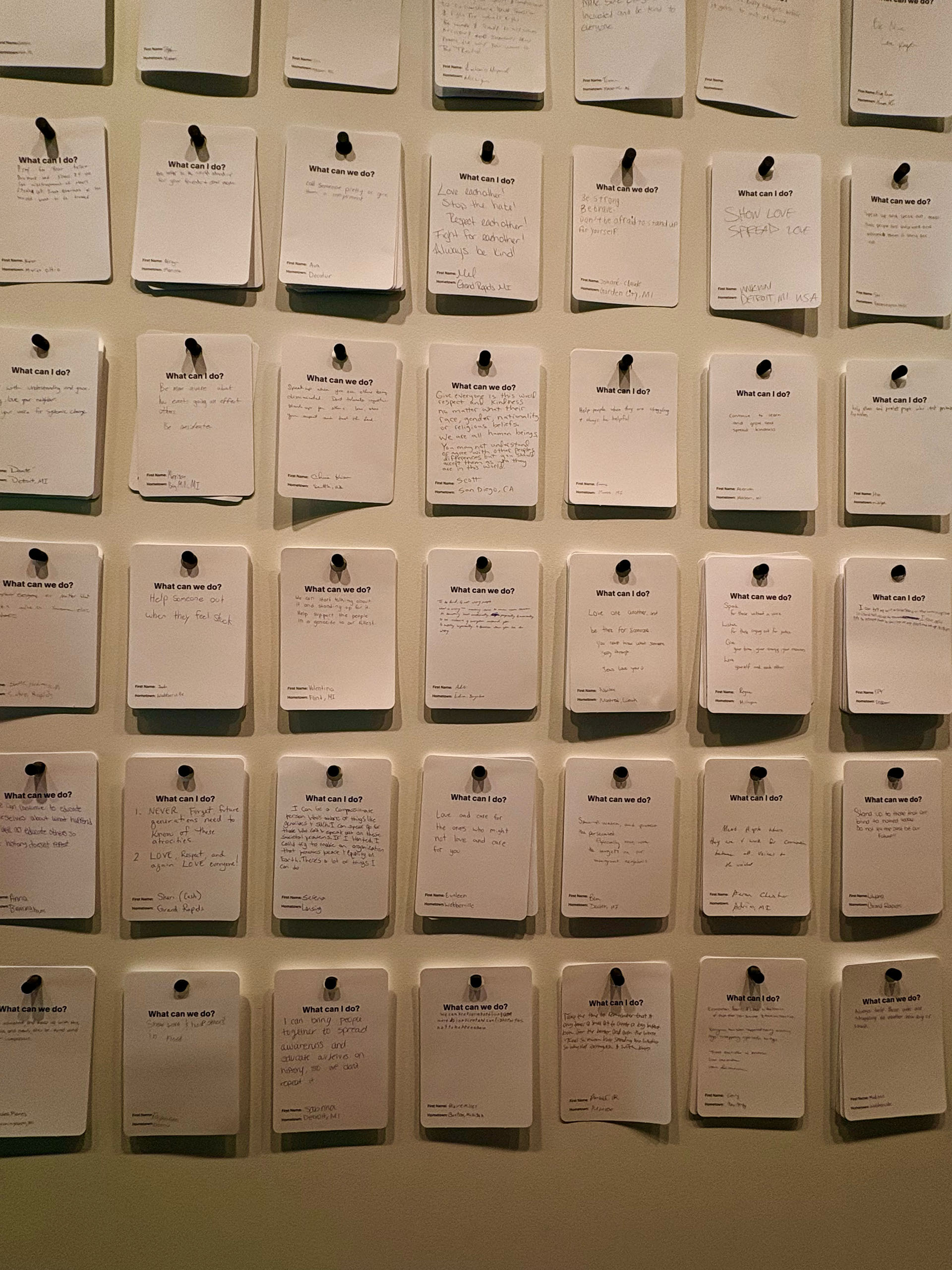 Close-up of a display of note cards on a wall
