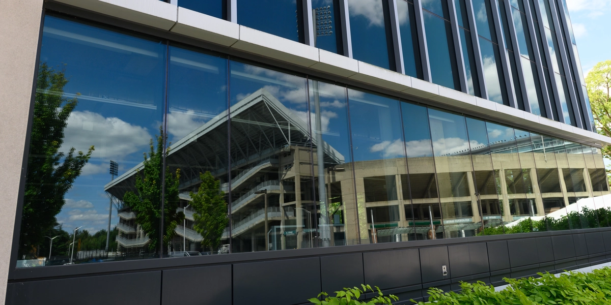 Reflections of Spartan Stadium in the windows of the STEM building