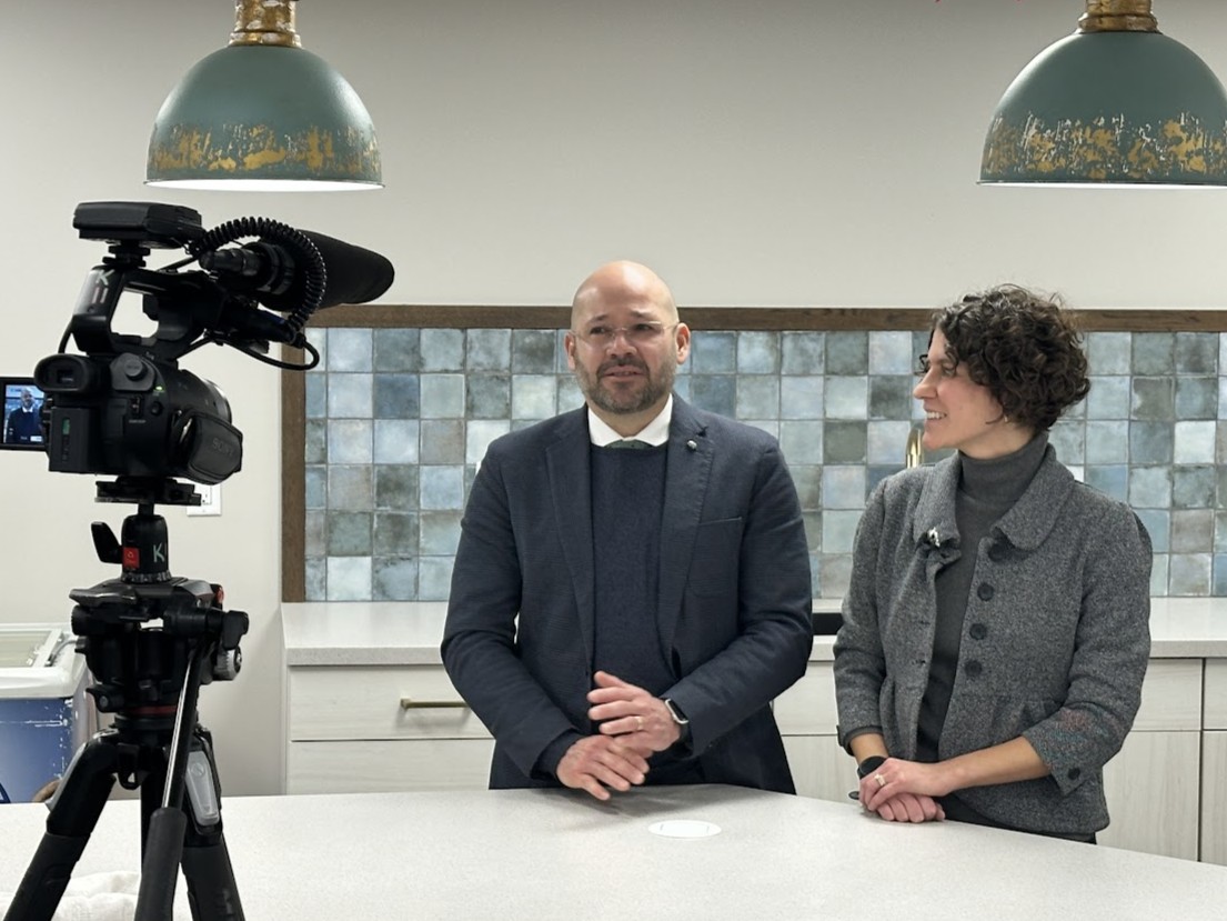 Irving Vega and Christine Skovira speaking in front of a camera