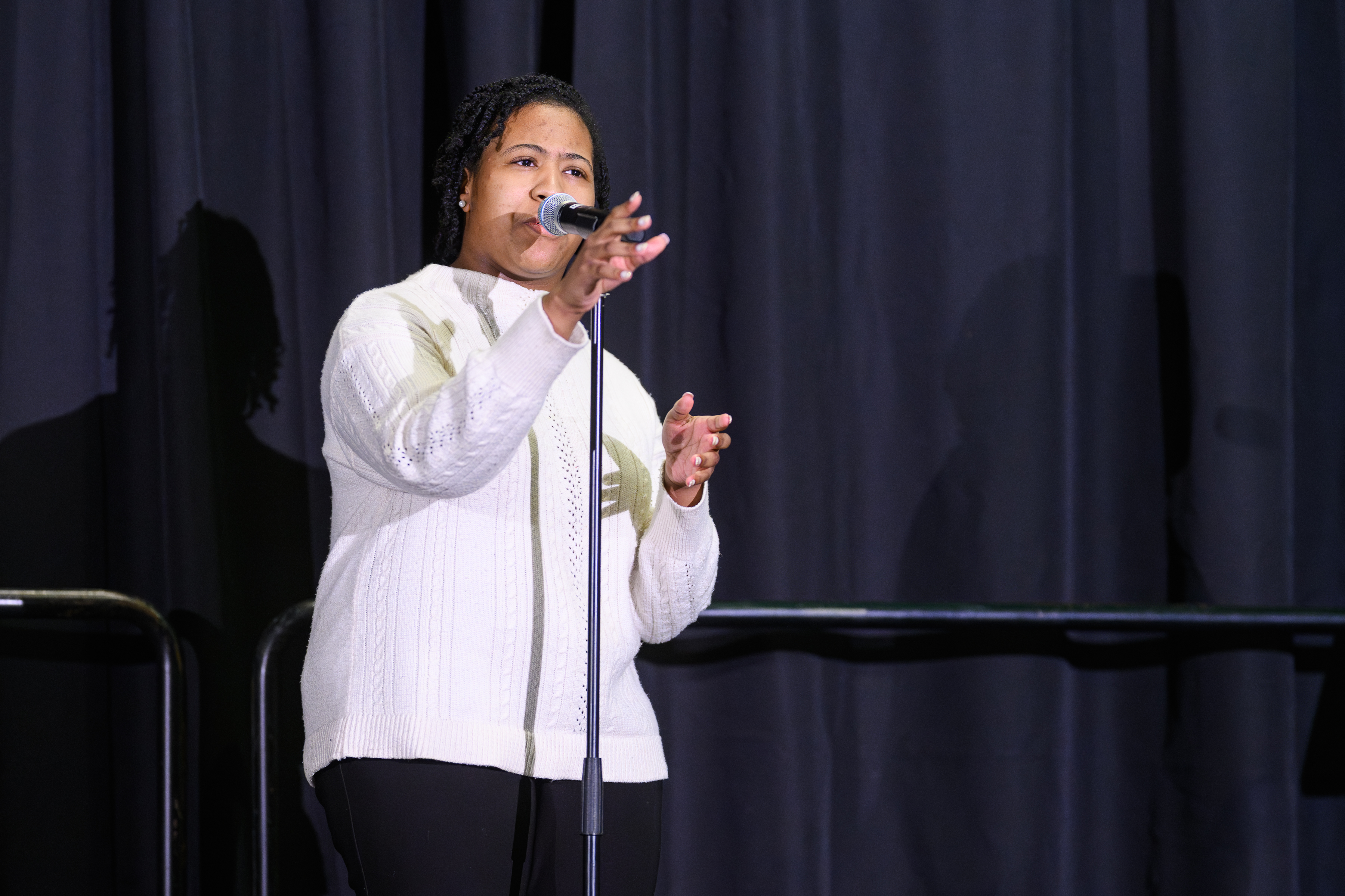 A woman speaks into a microphone