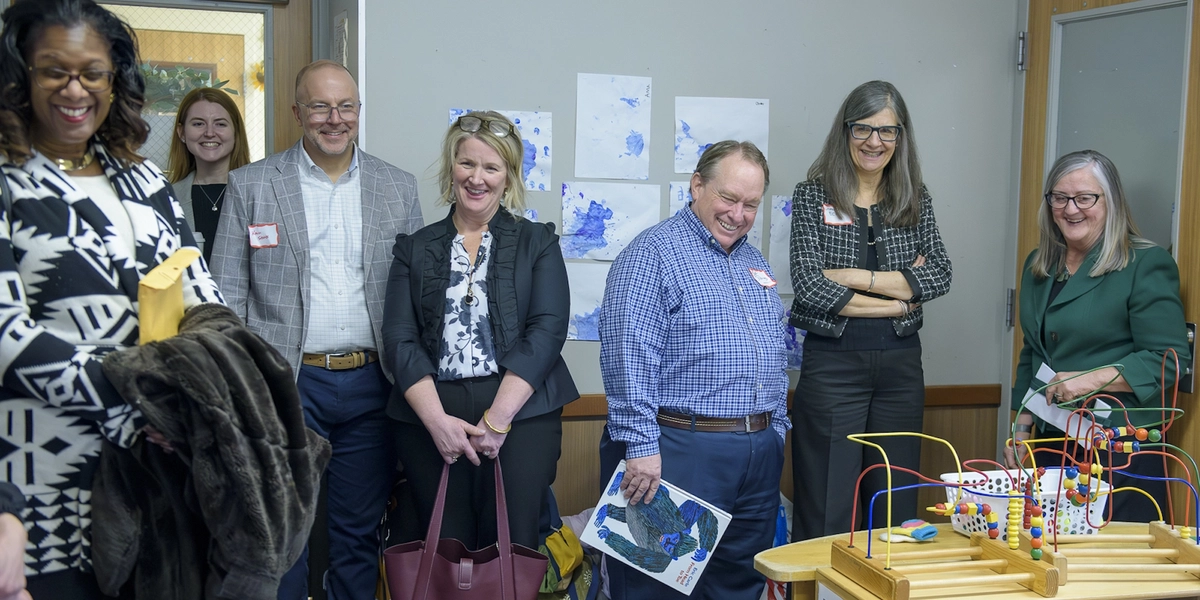 Individuals stand inside a child development facility for a tour.