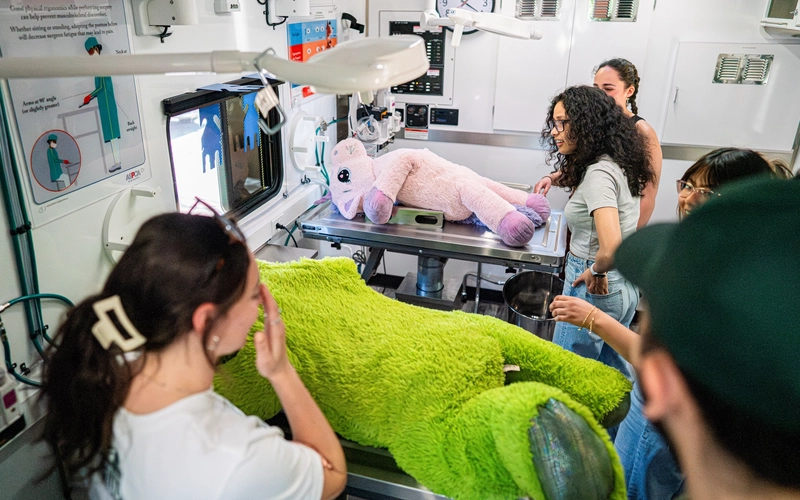 People get a first inside look of a new mobile veterinary clinic. Inside, they look at the equipment and stuffed animals acting as fake pets and animals that will soon be seen in the traveling clinic.