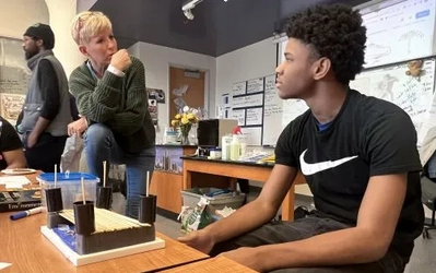 University Prep teacher Heidi Quick (left) talks with a student