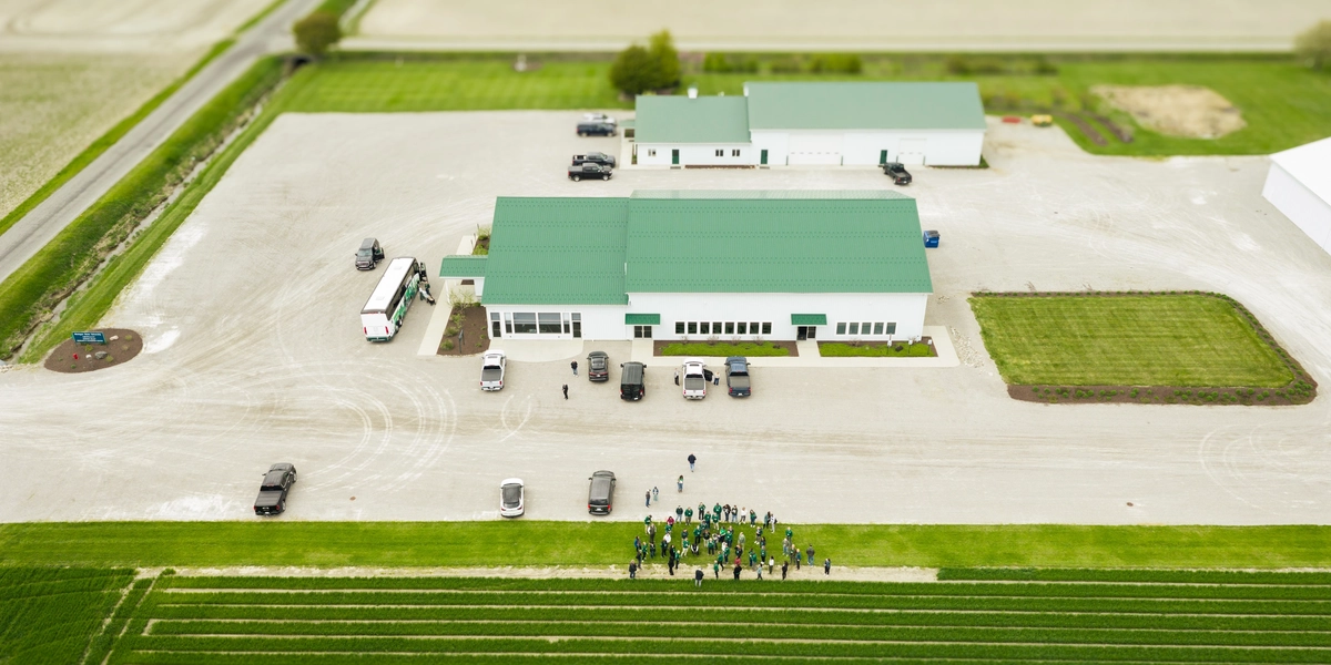 Aerial view of a farm with a barn and a group of people visible