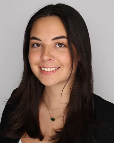 Professional headshot of Marissa Mills smiling at the camera against a neutral background.
