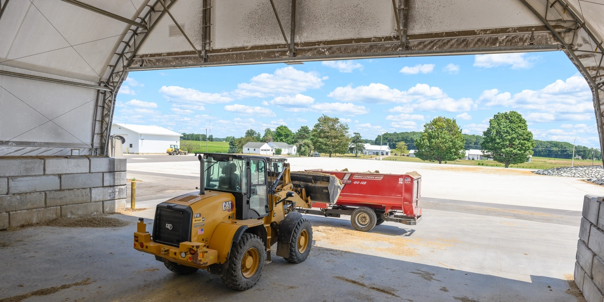 Person driving farm equipment at Dairy Cattle Teaching and Research Center