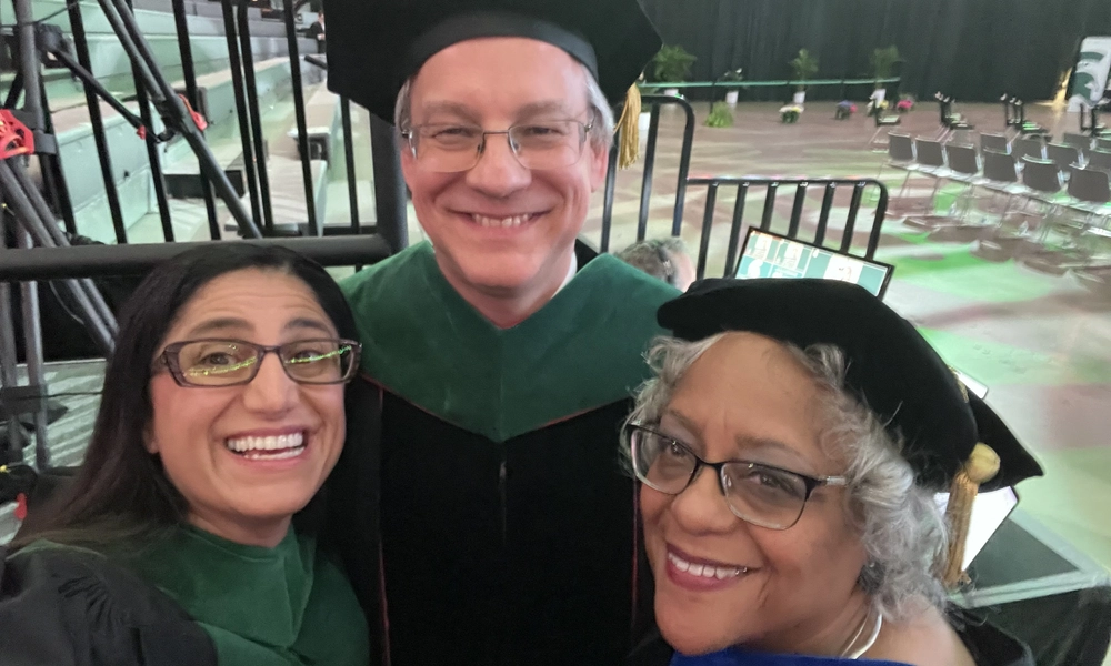 Dr. Mona Hanna, Dr. Aron Sousa, and Dr. Wanda Lipscomb smile for a selfie.
