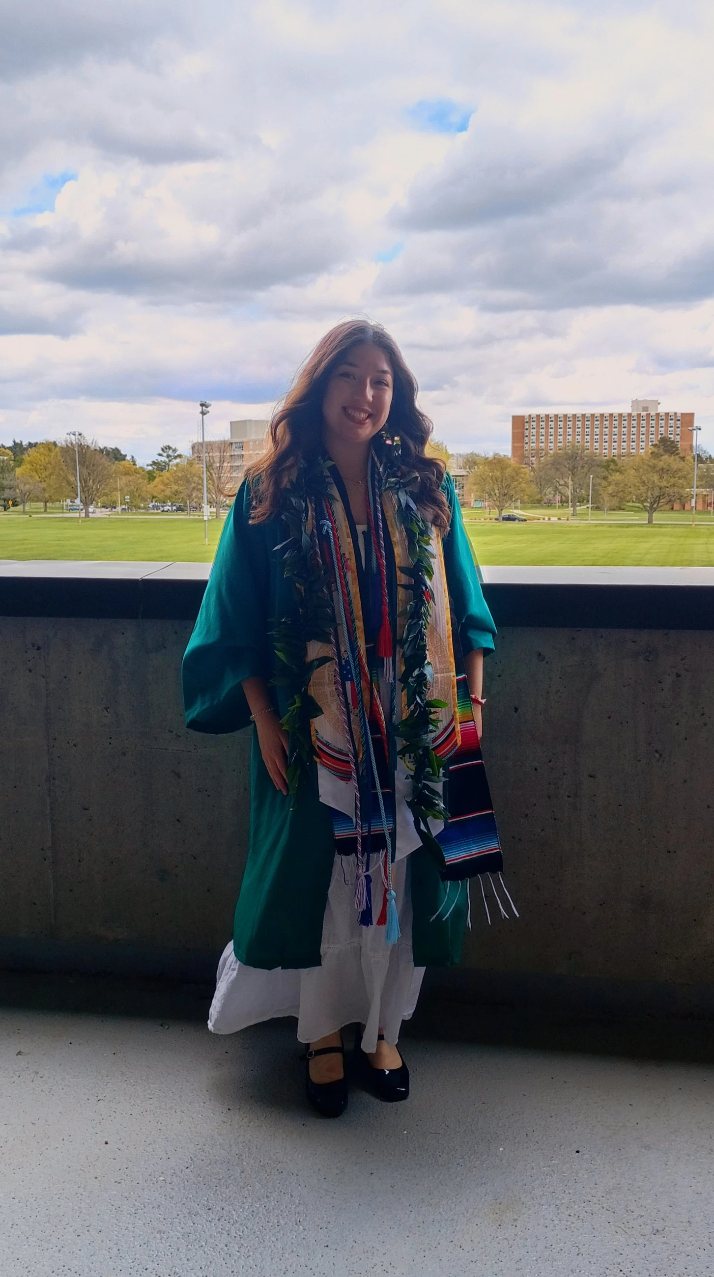 A woman wears a graduation gown