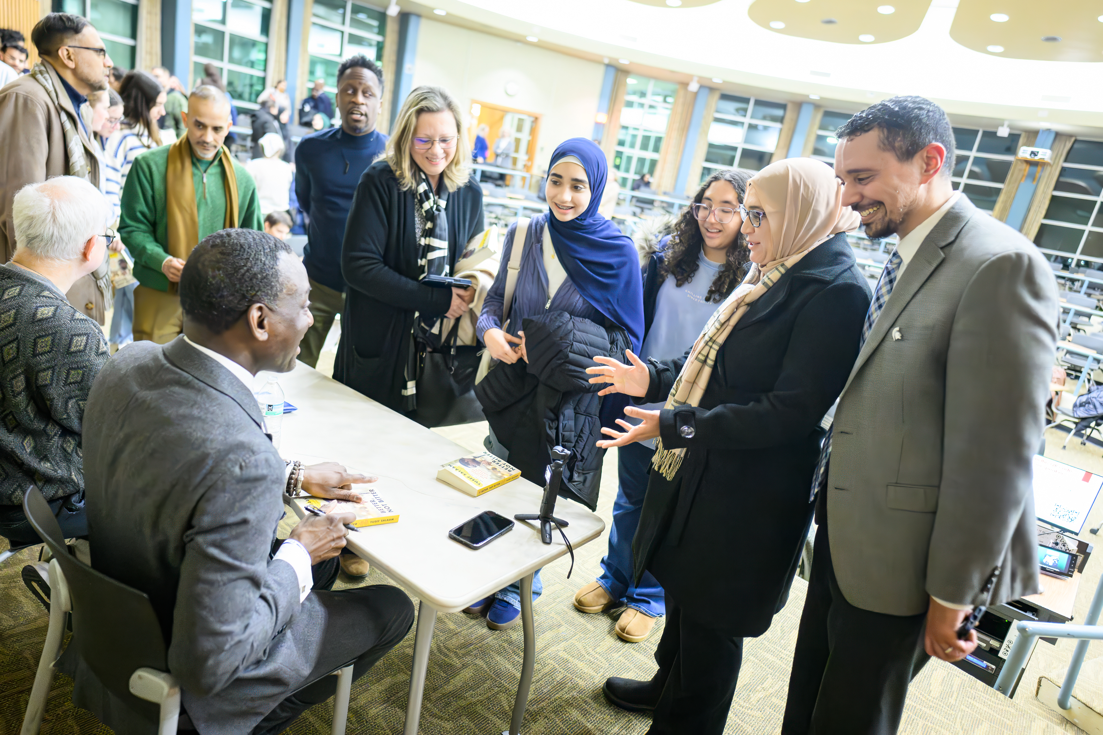 People stand in line for a book signing with the author