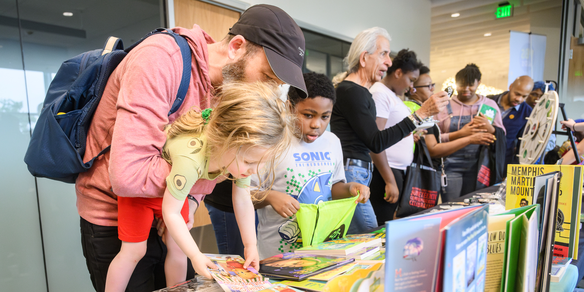 People look at books at a table display inside a building
