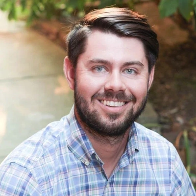 Headshot of Professor Ethan Theuerkauf.