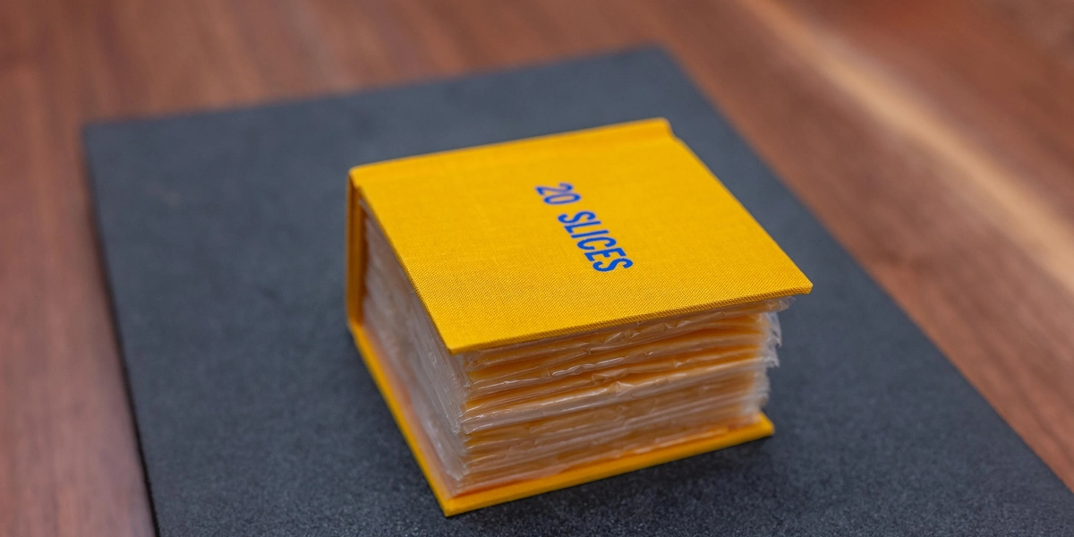 A hard-cover bound book made of 20 American Cheese slices.