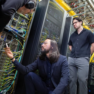 From left to right, Kelly Climber, Jose Mendoza, Daniel Maldonado Lopez, and Ismail Buliyaminu examine a super-fast InfiniBand cable in ICER's high-performance computing center.