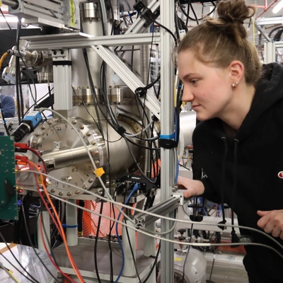 Female student involved in hands-on training for radiation testing.