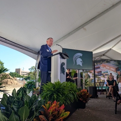 A man giving a speech at a podium,