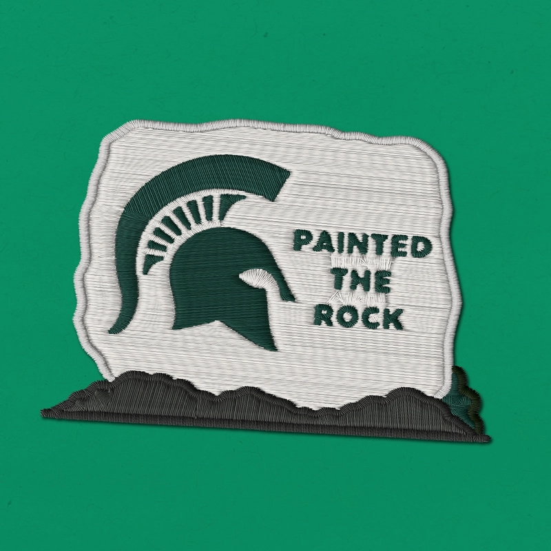 Embroidered patch reading "Painted the Rock" with a Spartan helmet on the Rock on a green background.