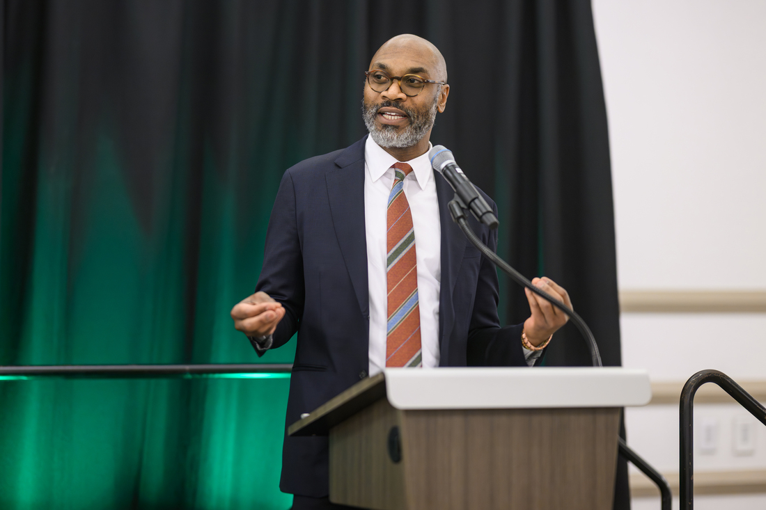 A man speaks at a lectern