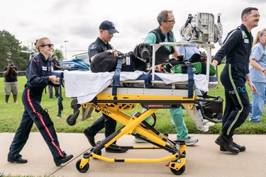 Photo of a black lab service dog on a stretcher as part of Spartan Shield MSU Campus Test, which is the new College of Vet Med program that airlifts wounded service dogs to the MSU Vet Medical Center.