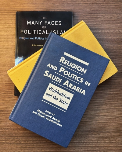 Papers presented at the inaugural Muslim Studies Conference, held April 7-8, 2006, were later published in “Religion and Politics in Saudi Arabia: Wahhabism and the State,” pictured atop two other books. Photo by Earlene Ling.