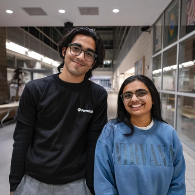 Two students pose for a photo, both wearing sweatshirts