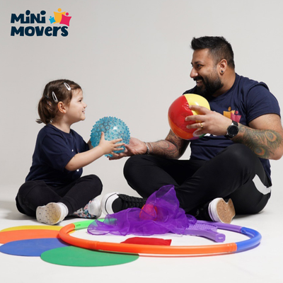 Adult and child playing with toys