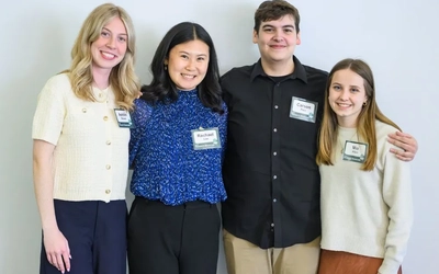 Rachael Lee standing with three fellow JMC Human Rights Data Science Lab student leaders during the 2026 Research Showcase.