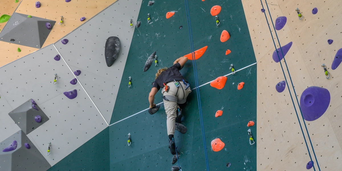 Person climbing rock wall